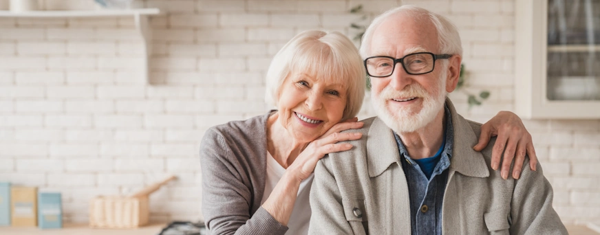 Life Assure Senior Wife Husband Posing In Kitchen Hero